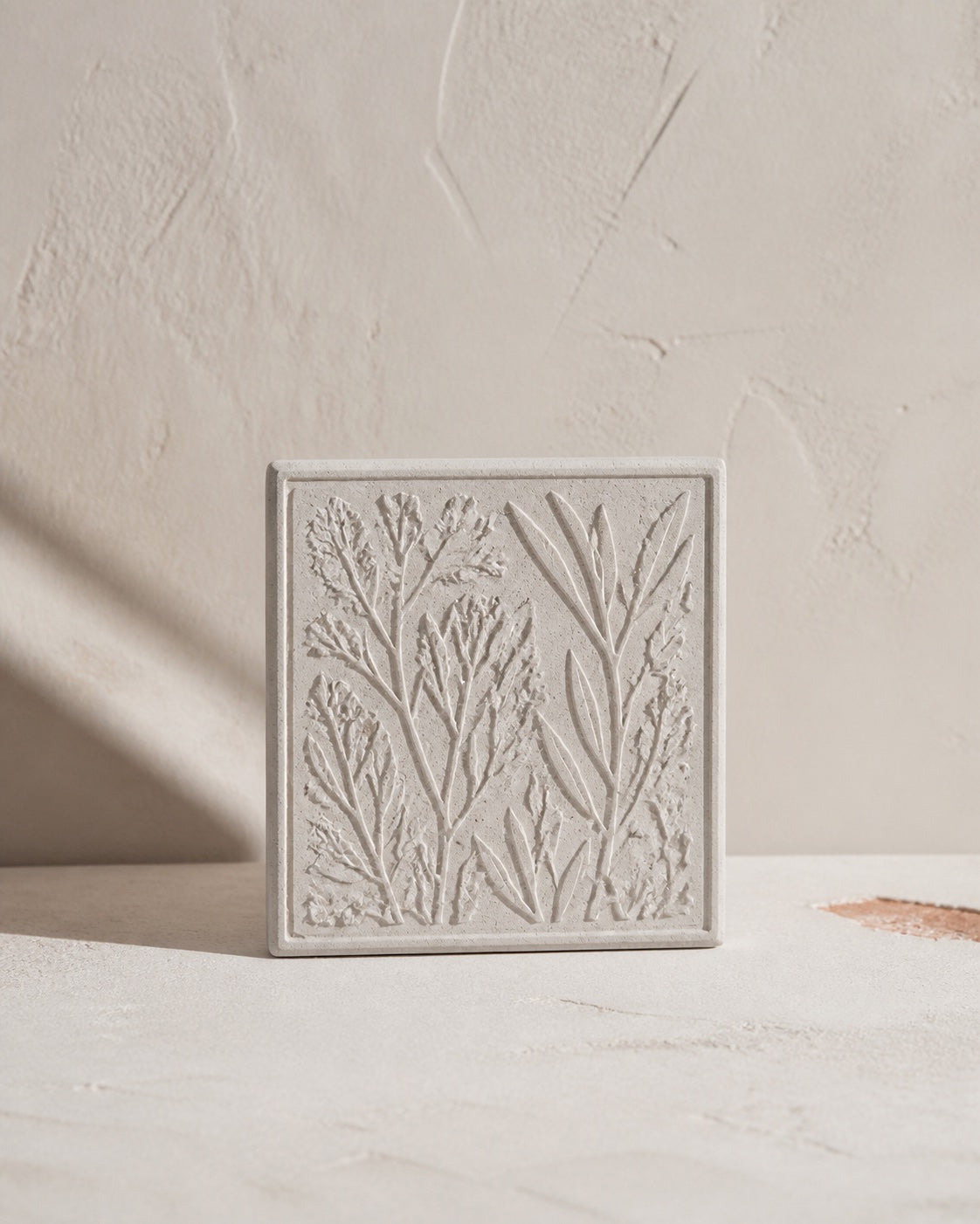 Detailed botanical relief reproduced in a mineral cast tile