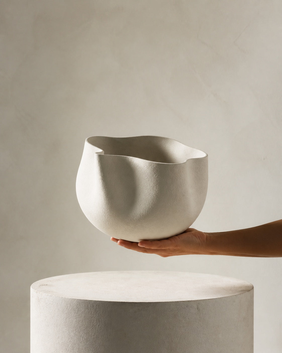 Lightweight sculptural cast vessel balanced on one hand