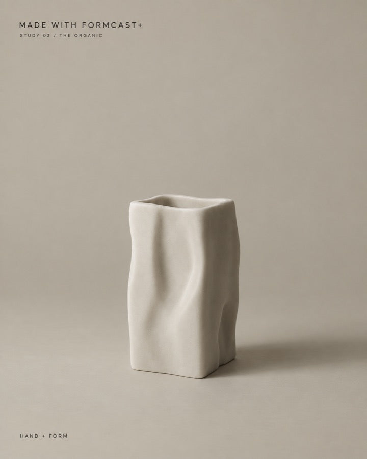 A tall cast vase with a folded surface