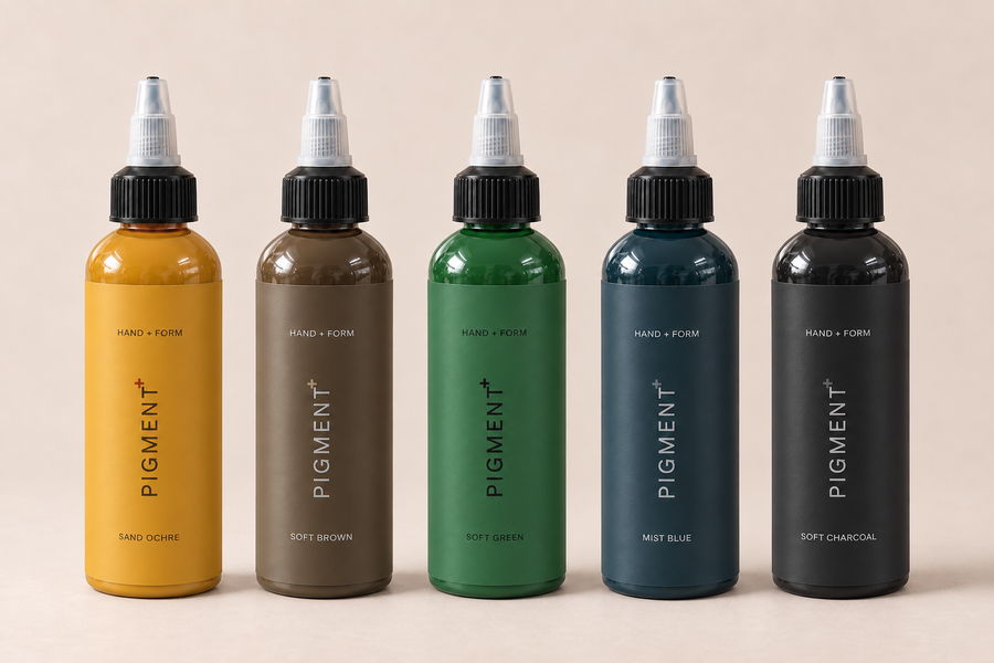 Five HAND + FORM Pigment+ bottles: Sand Ochre, Soft Brown, Soft Green, Mist Blue and Soft Charcoal, side by side.