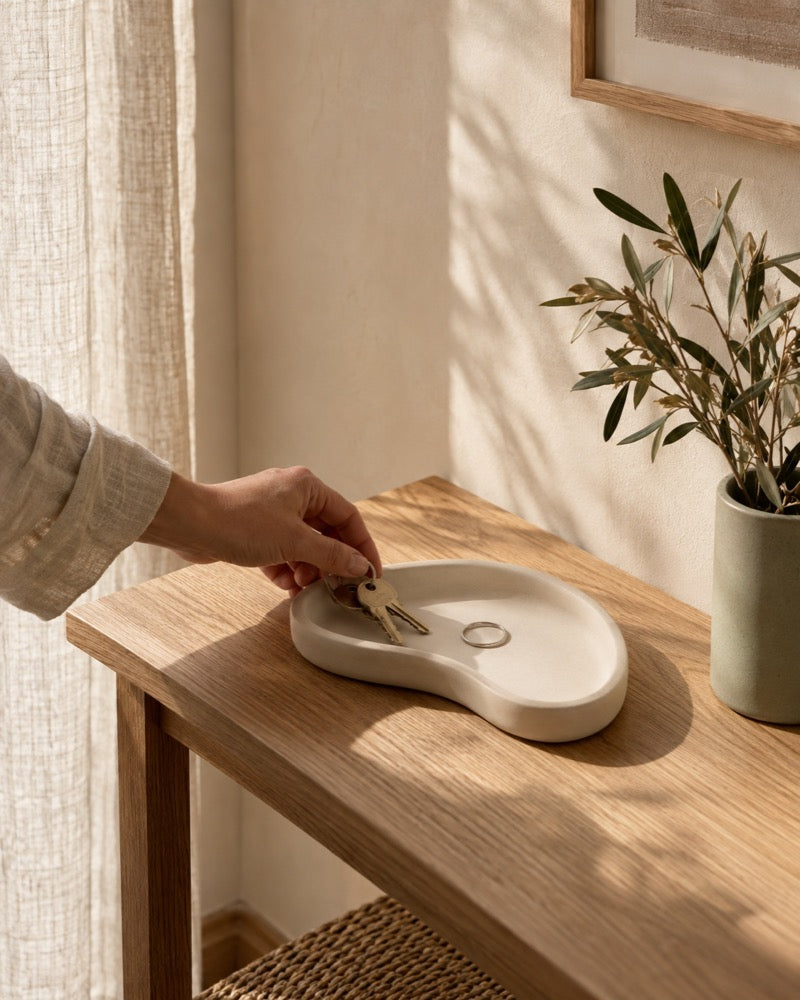 A pale cast tray on a hallway table