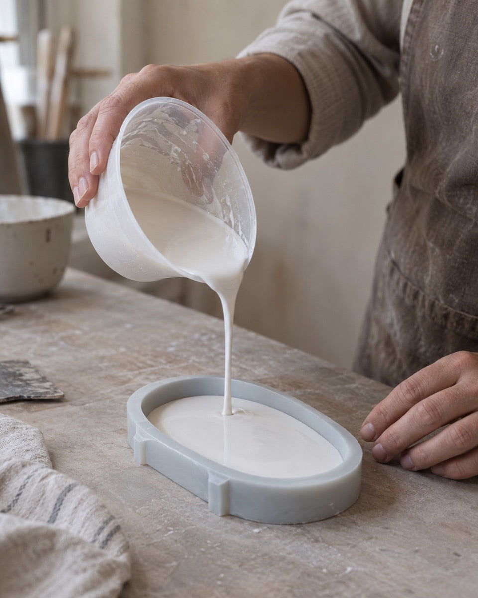 Pouring casting mix into an oval silicone mould